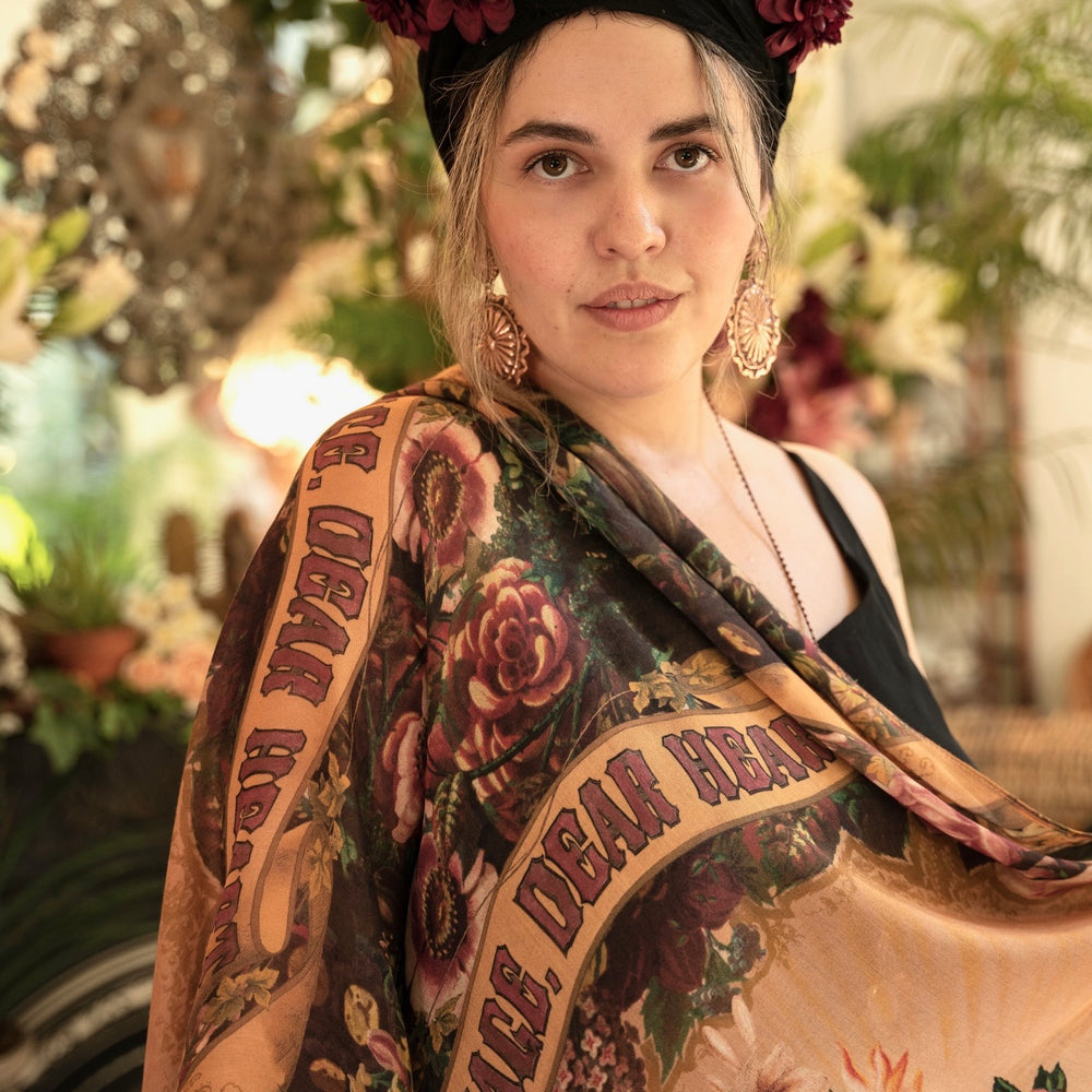 
                  
                    Model wearing Courage Dear Heart scarf featuring Victorian lithographs, Sacred Heart art, and hidden messages of love, faith, and courage on soft bamboo viscose – Market of Stars
                  
                