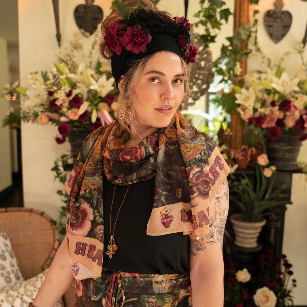 
                  
                    Model wearing Courage Dear Heart scarf featuring Victorian lithographs, Sacred Heart art, and hidden messages of love, faith, and courage on soft bamboo viscose – Market of Stars
                  
                