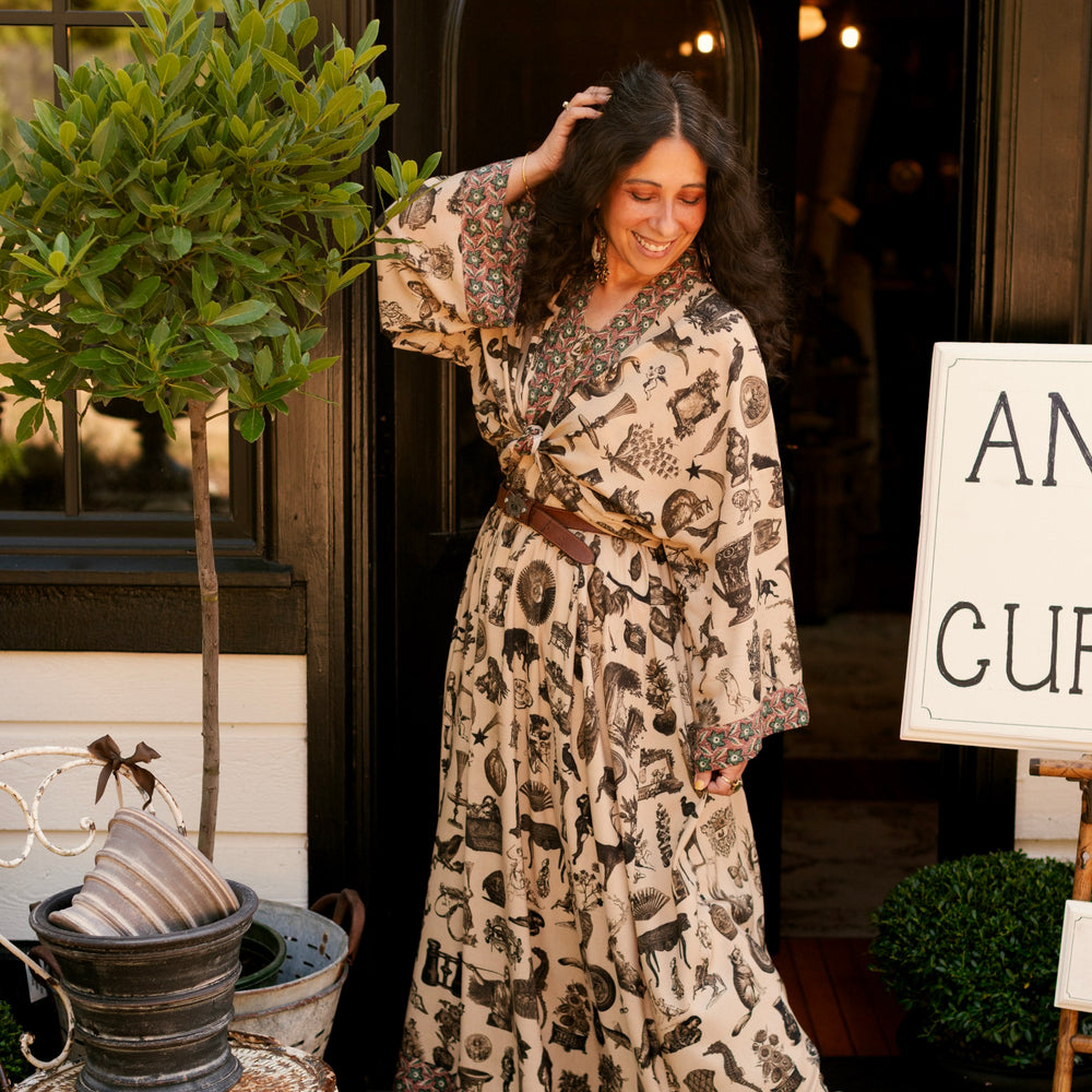 
                  
                    Model wearing a maxi-length bamboo viscose slip dress inspired by a mysterious Victorian scrapbook. This whimsical print celebrates the wonder hidden in ordinary things — Market of Stars.
                  
                