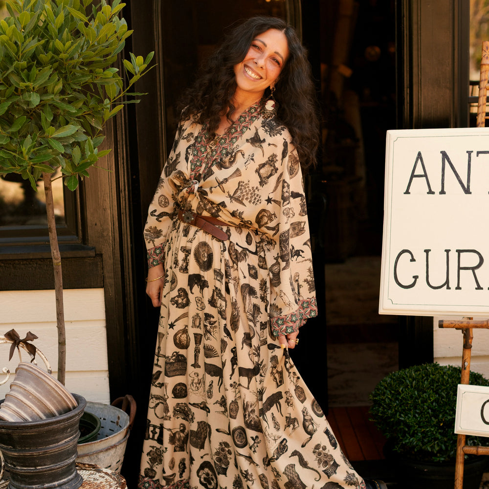 
                  
                    Model wearing a maxi-length bamboo viscose slip dress inspired by a mysterious Victorian scrapbook. This whimsical print celebrates the wonder hidden in ordinary things — Market of Stars.
                  
                