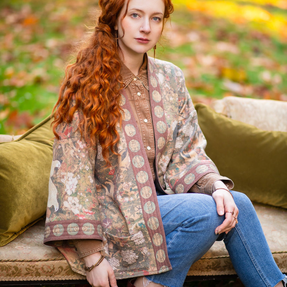 Model wearing Dreamweaver Cottage Cardigan featuring Mucha’s 1896 zodiac woman with celestial crown, printed on cozy fleece-lined cotton blend – Market of Stars