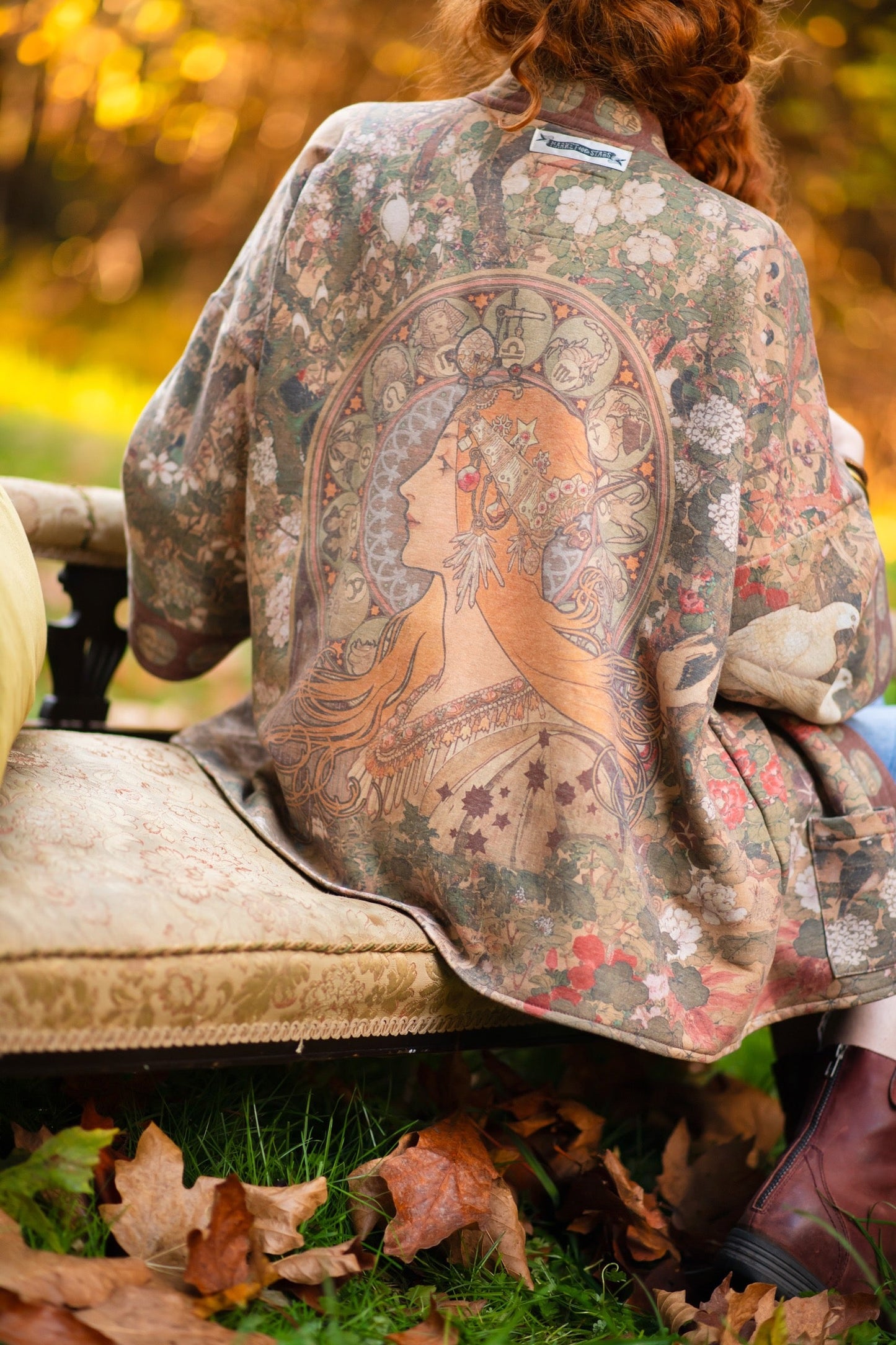 Model wearing Dreamweaver Cottage Cardigan featuring Mucha’s 1896 zodiac woman with celestial crown, printed on cozy fleece-lined cotton blend – Market of Stars