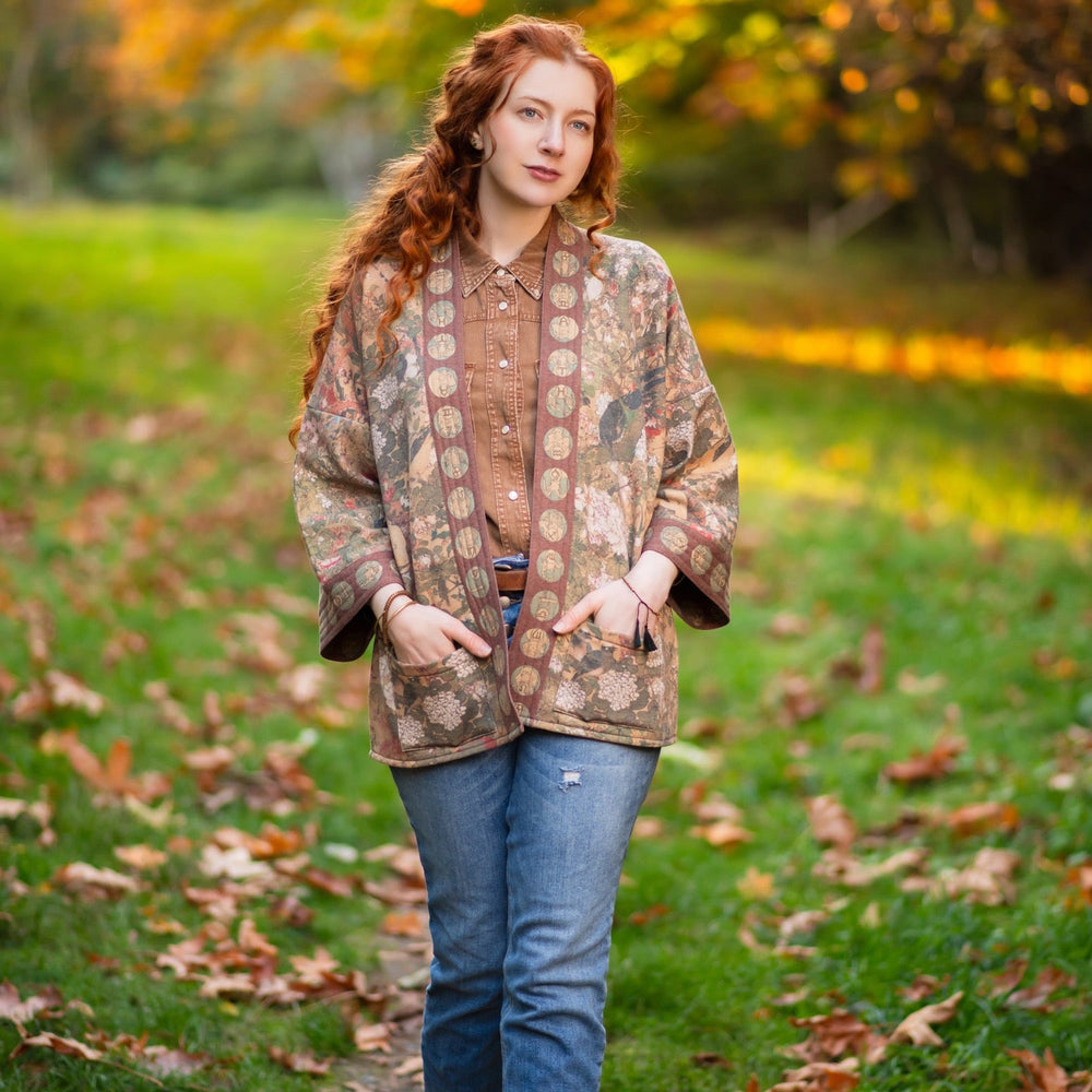 
                  
                    Model wearing Dreamweaver Cottage Cardigan featuring Mucha’s 1896 zodiac woman with celestial crown, printed on cozy fleece-lined cotton blend – Market of Stars
                  
                