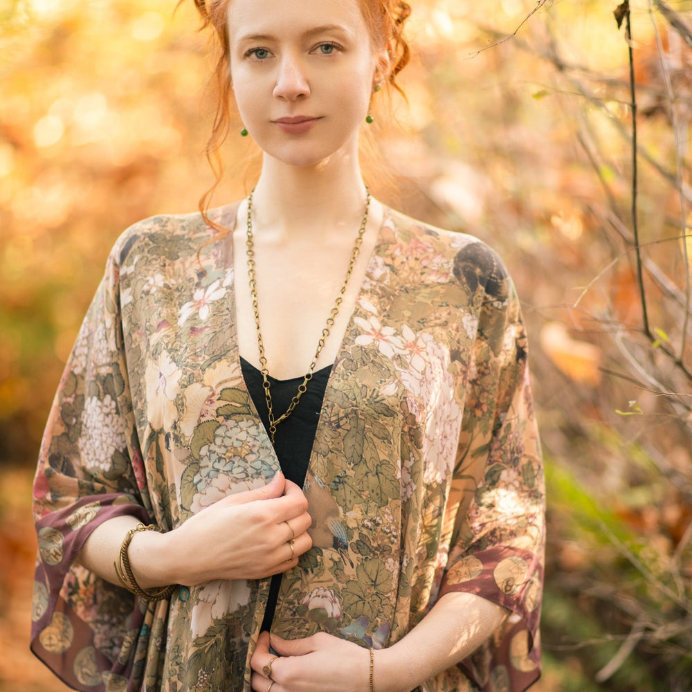 
                  
                    Dreamweaver Goddess Duster featuring Alphonse Mucha’s 1896 zodiac woman, celestial crown, and burgundy zodiac trim inspired by vintage bohemian style – Market of Stars
                  
                