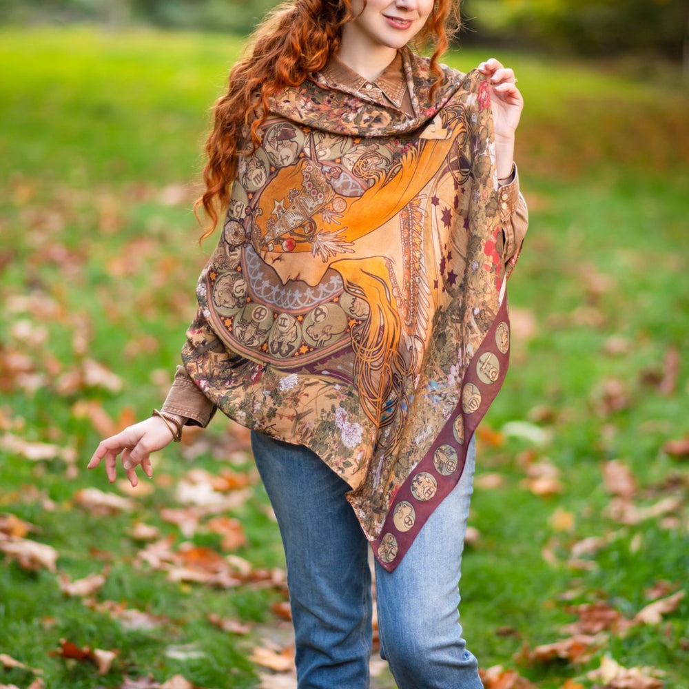Model wearing Dreamweaver Zodiac Scarf – featuring Alphonse Mucha’s 1896 celestial woman surrounded by zodiac signs and floral scroll artwork – Market of Stars.