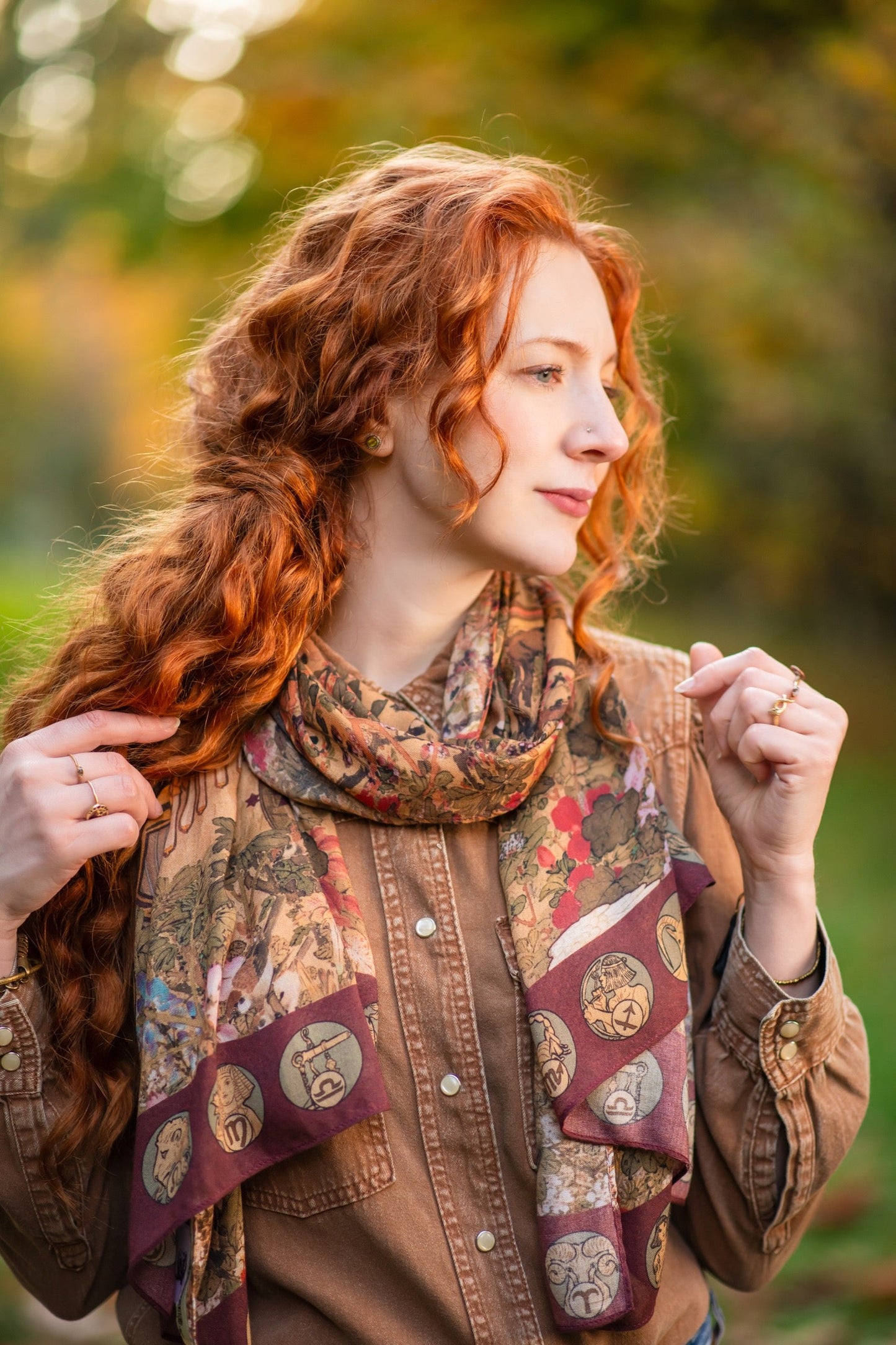 Model wearing Dreamweaver Zodiac Scarf – featuring Alphonse Mucha’s 1896 celestial woman surrounded by zodiac signs and floral scroll artwork – Market of Stars.