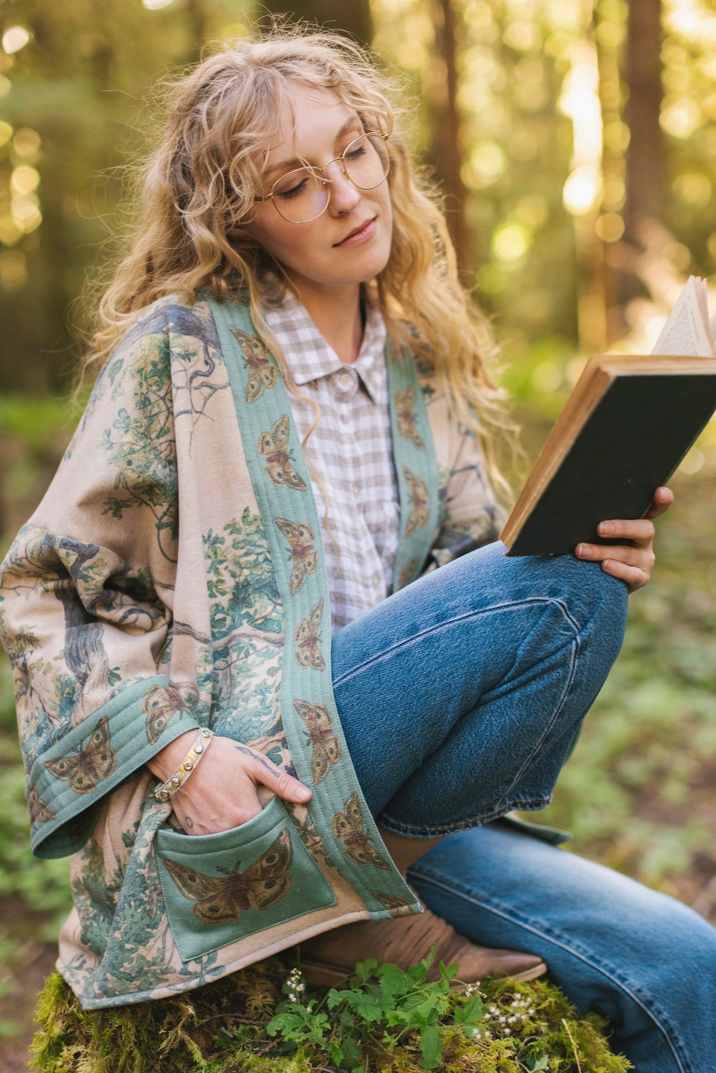 Model wearing Earth and Sky Cottage Jacket – featuring Charles Aston’s tree painting and antique moth art – cozy fleece-lined cardigan for cooler days – Market of Stars.