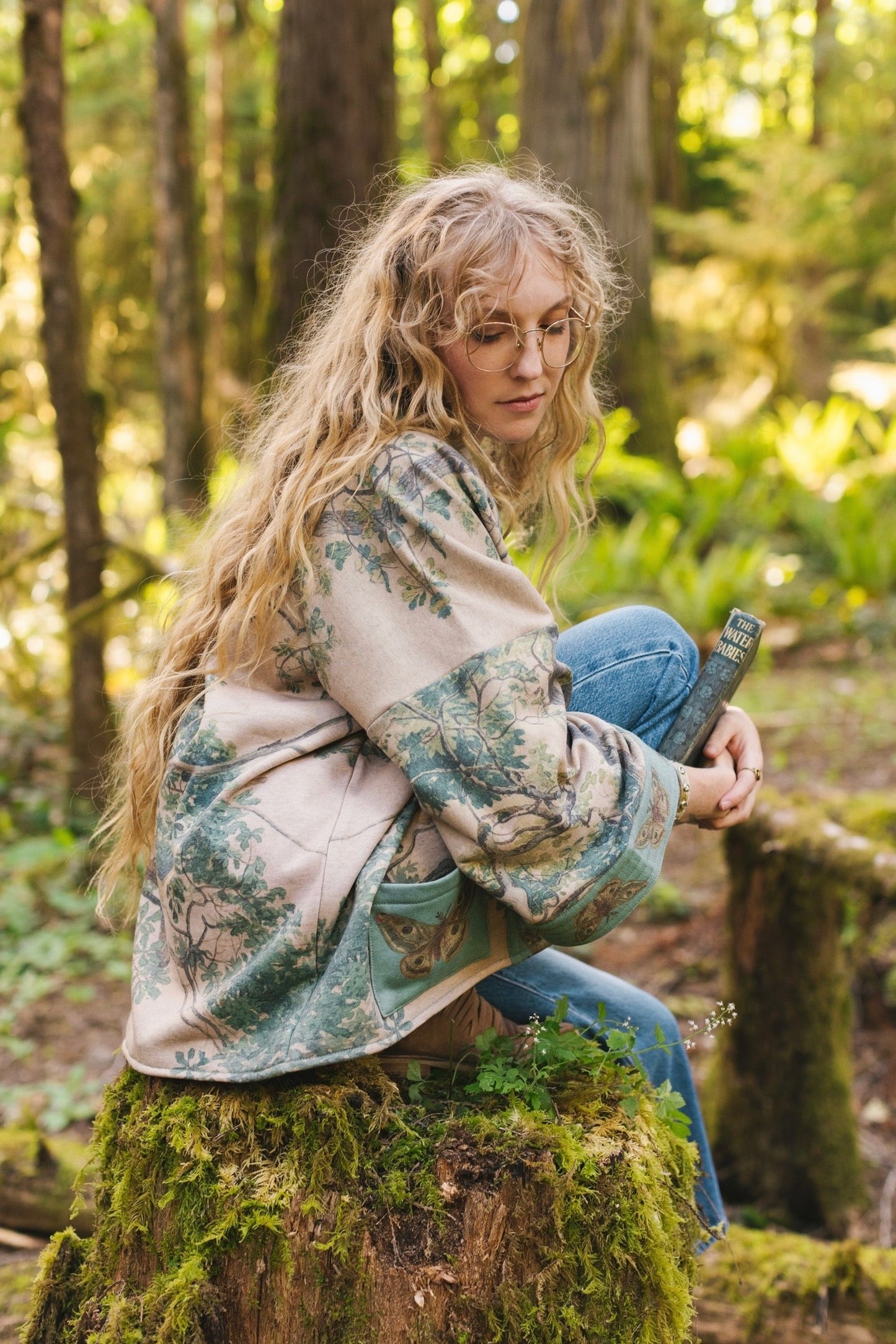 Model wearing Earth and Sky Cottage Jacket – featuring Charles Aston’s tree painting and antique moth art – cozy fleece-lined cardigan for cooler days – Market of Stars.