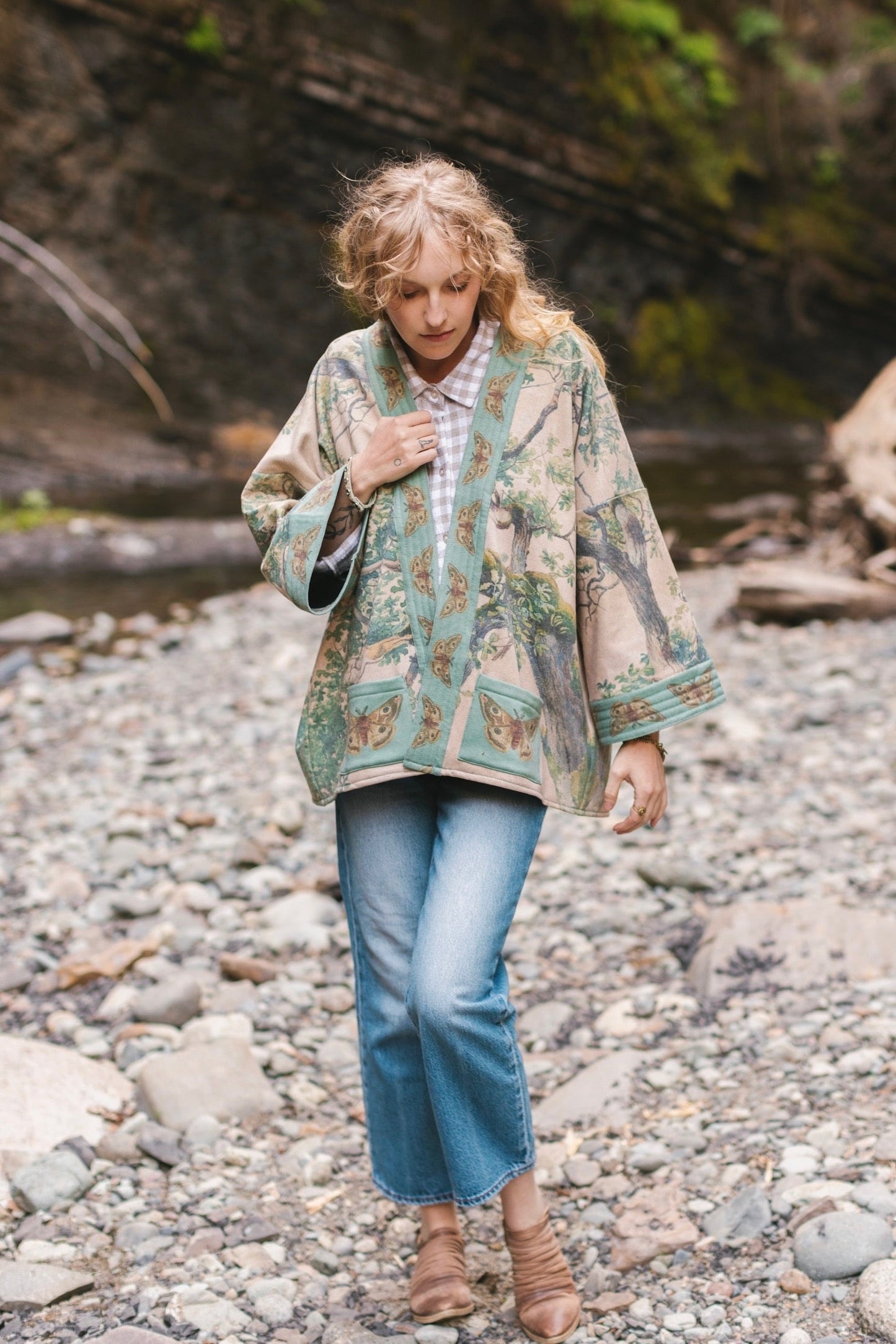Model wearing Earth and Sky Cottage Jacket – featuring Charles Aston’s tree painting and antique moth art – cozy fleece-lined cardigan for cooler days – Market of Stars.