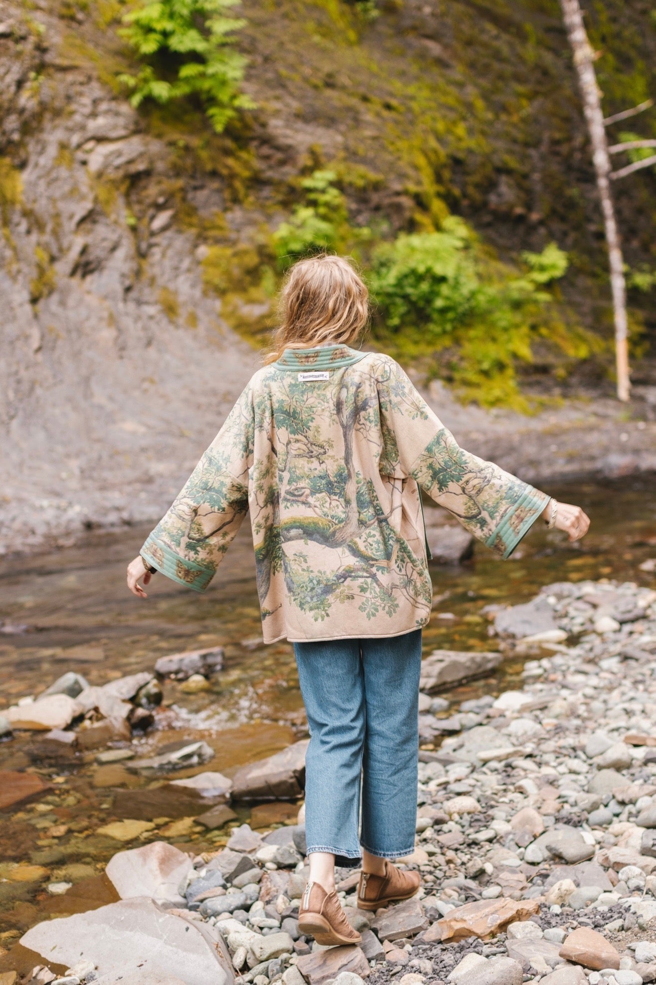 Model wearing Earth and Sky Cottage Jacket – featuring Charles Aston’s tree painting and antique moth art – cozy fleece-lined cardigan for cooler days – Market of Stars.