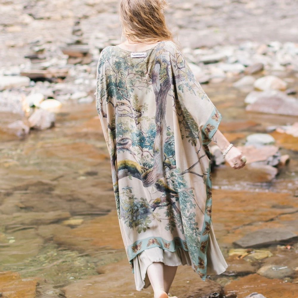 
                  
                    Model wearing the Earth and Sky Goddess length kimono featuring majestic trees by Charles Aston and antique moth illustrations – a dreamy tribute to nature – Market of Stars.
                  
                
