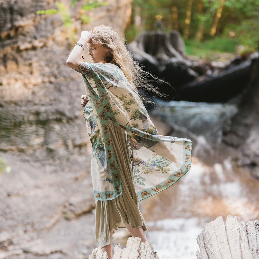 
                  
                    Model wearing the Earth and Sky Goddess length kimono featuring majestic trees by Charles Aston and antique moth illustrations – a dreamy tribute to nature – Market of Stars.
                  
                