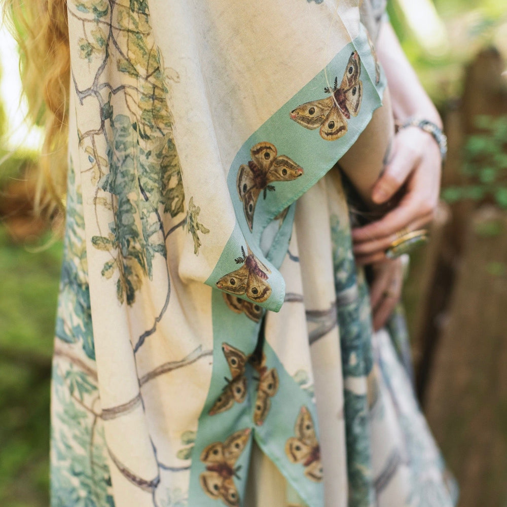 
                  
                    Model wearing the Earth and Sky Goddess length kimono featuring majestic trees by Charles Aston and antique moth illustrations – a dreamy tribute to nature – Market of Stars.
                  
                