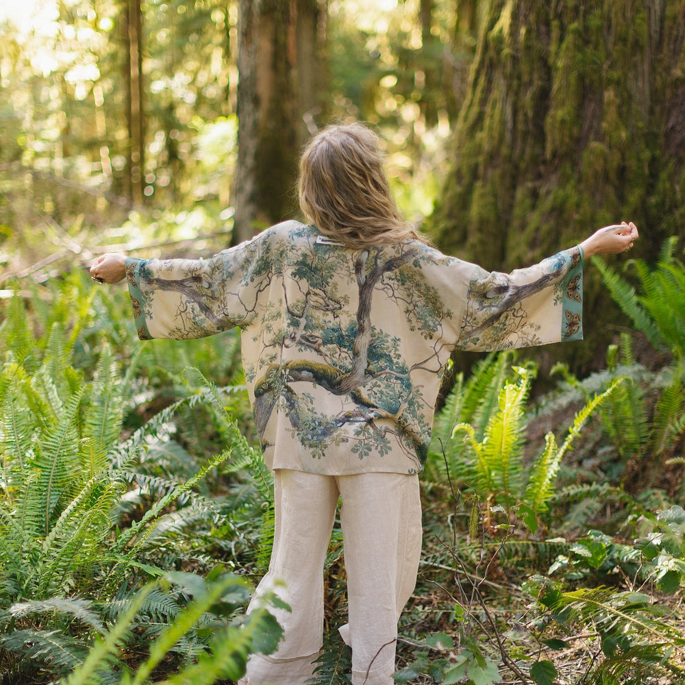 
                  
                    Model wearing Earth and Sky Pixie Duster featuring Charles Aston’s tree art and antique moth illustrations – a soft, nature-inspired layering piece – Market of Stars.
                  
                