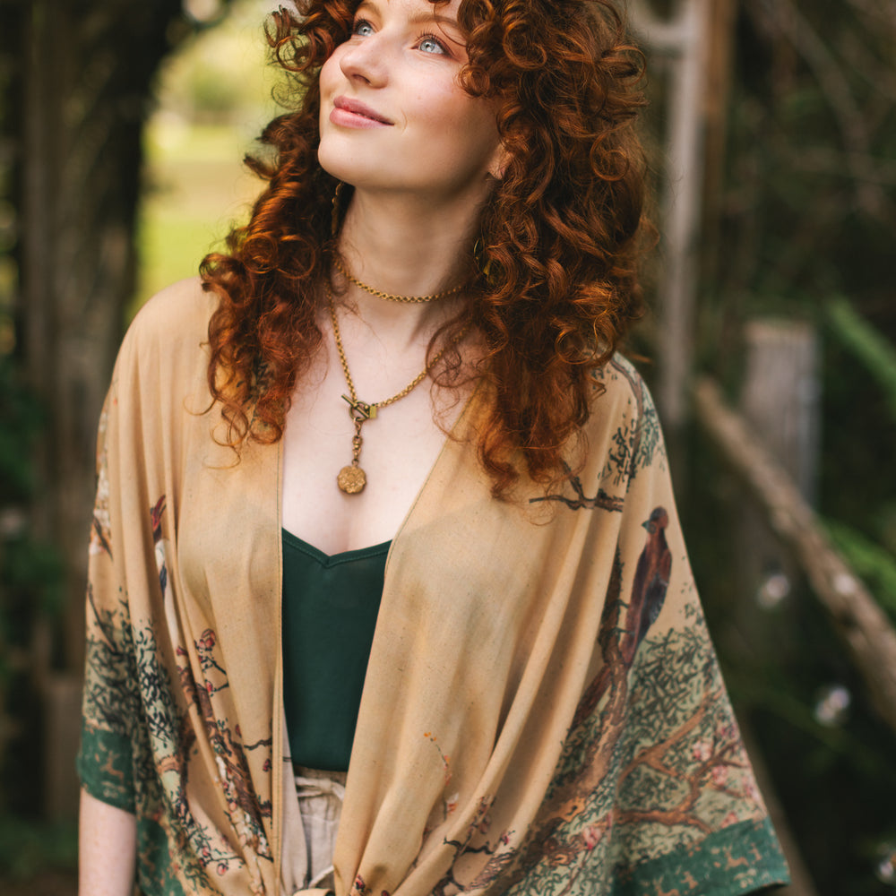 
                  
                    Model wearing Fable Goddess Duster featuring antique Japanese art, cherry and peach blossoms, nightingales, deer, and French block prints - Market of Stars
                  
                