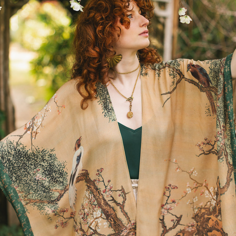 
                  
                    Model wearing Fable Goddess Duster featuring antique Japanese art, cherry and peach blossoms, nightingales, deer, and French block prints - Market of Stars
                  
                