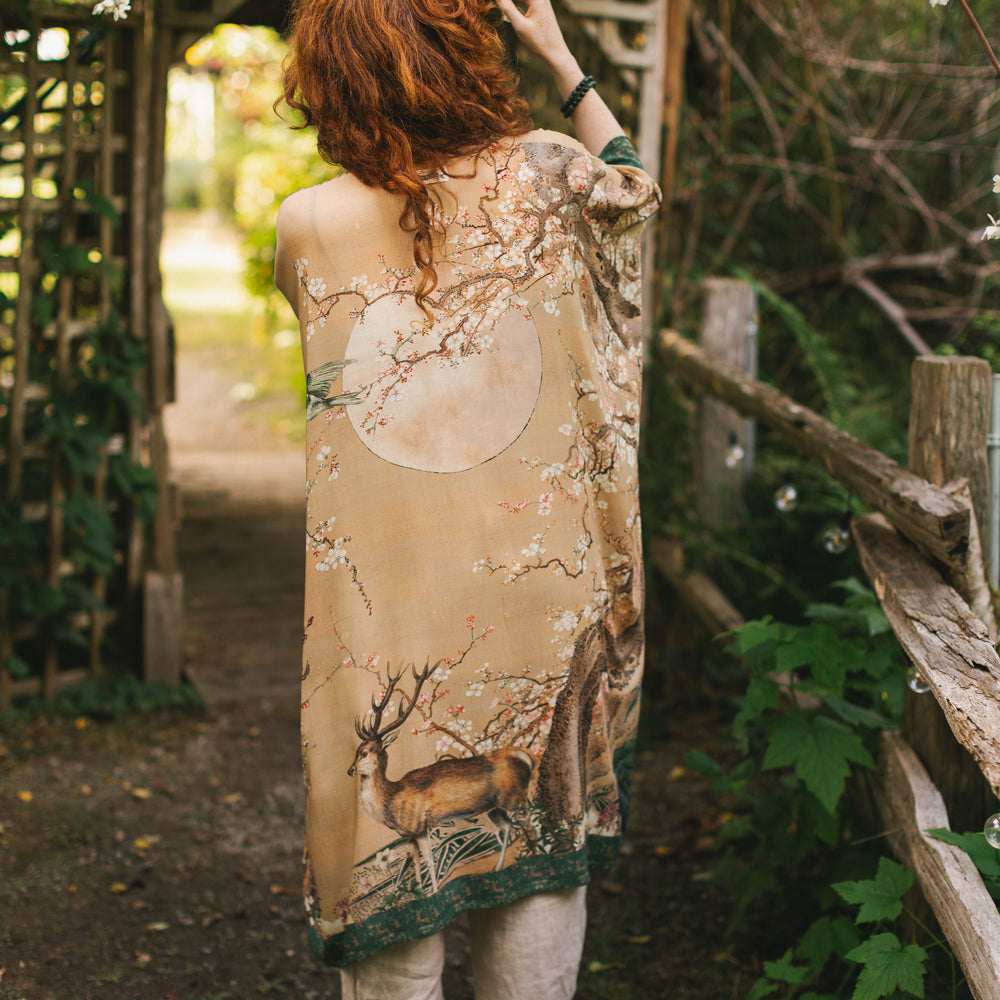 
                  
                    Model wearing Fable Goddess Duster featuring antique Japanese art, cherry and peach blossoms, nightingales, deer, and French block prints - Market of Stars
                  
                