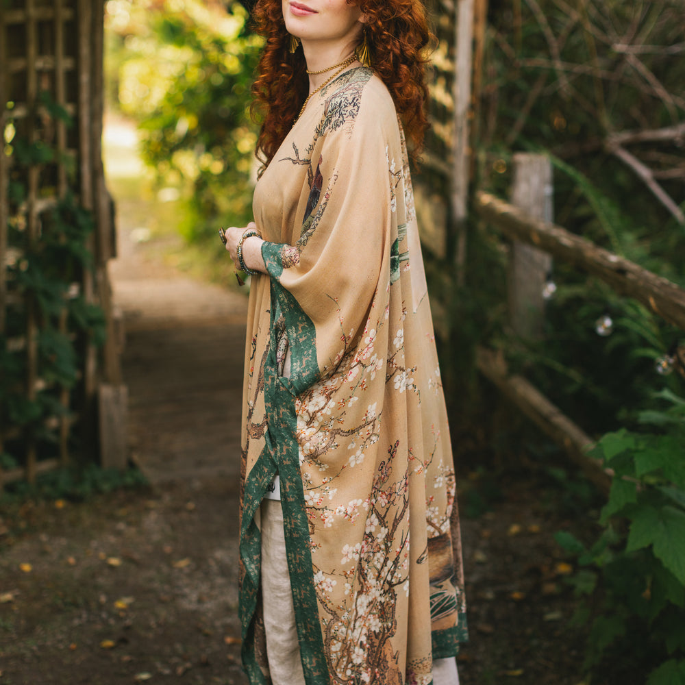 
                  
                    Model wearing Fable Goddess Duster featuring antique Japanese art, cherry and peach blossoms, nightingales, deer, and French block prints - Market of Stars
                  
                