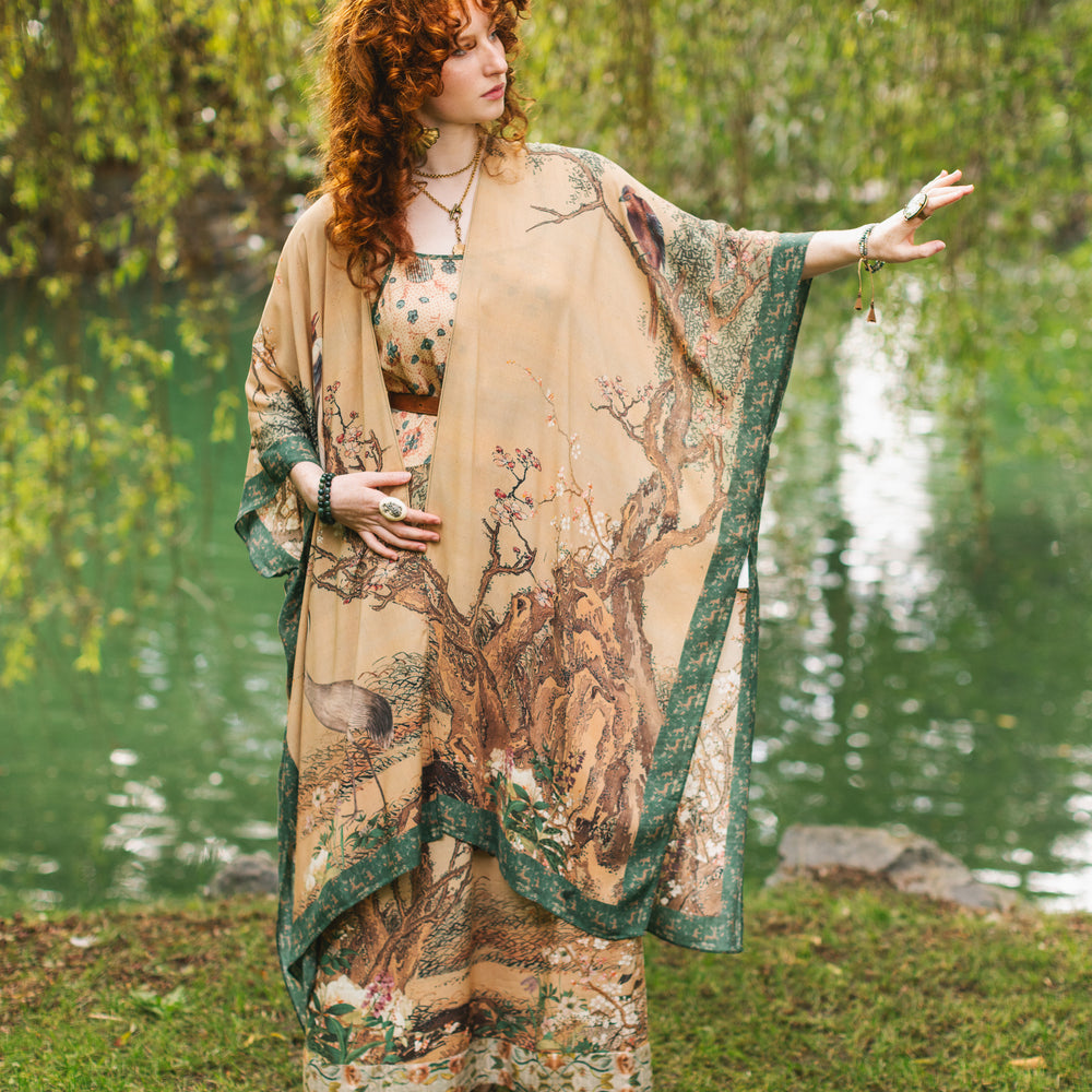 
                  
                    Model wearing Fable Goddess Duster featuring antique Japanese art, cherry and peach blossoms, nightingales, deer, and French block prints - Market of Stars
                  
                