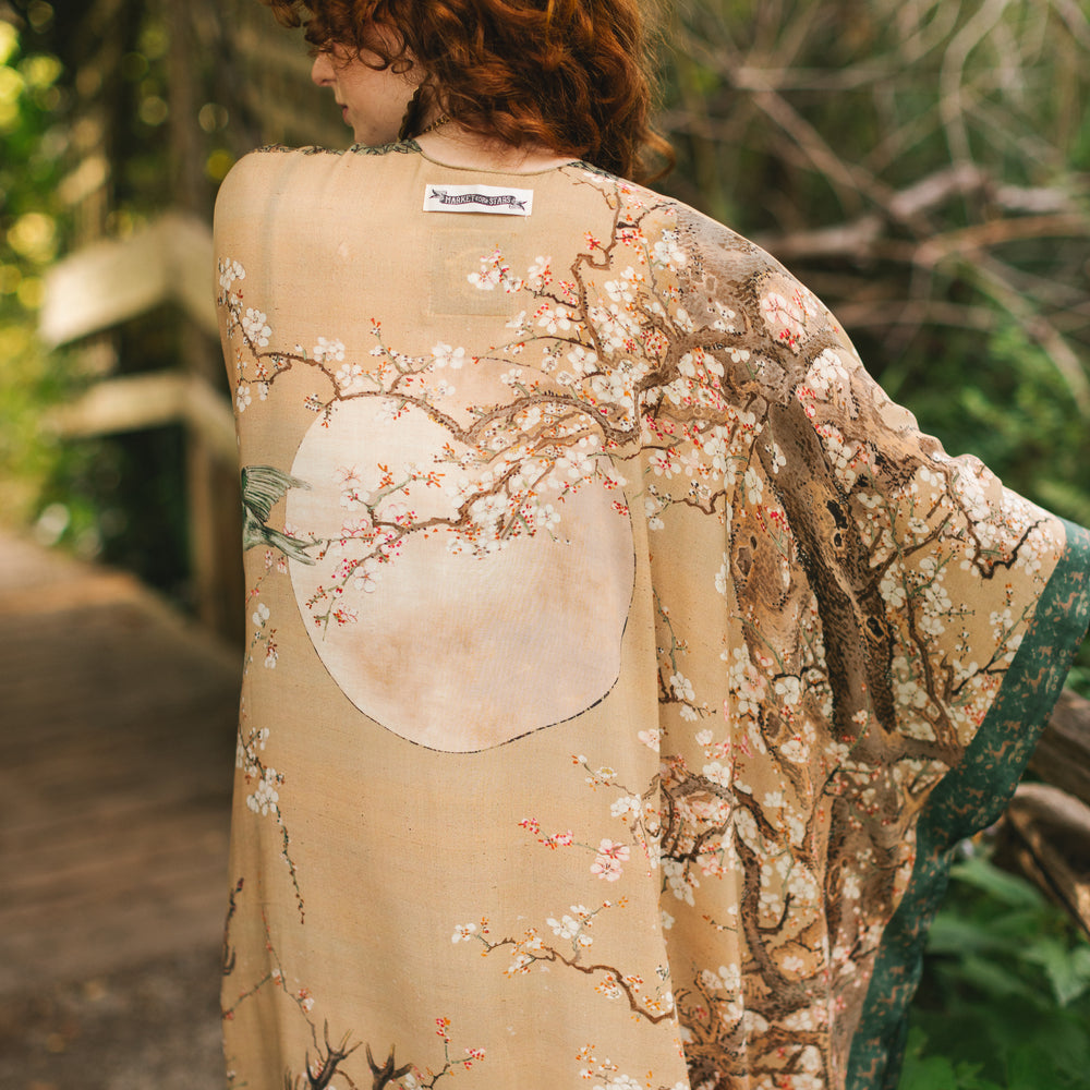 
                  
                    Model wearing Fable Goddess Duster featuring antique Japanese art, cherry and peach blossoms, nightingales, deer, and French block prints - Market of Stars
                  
                