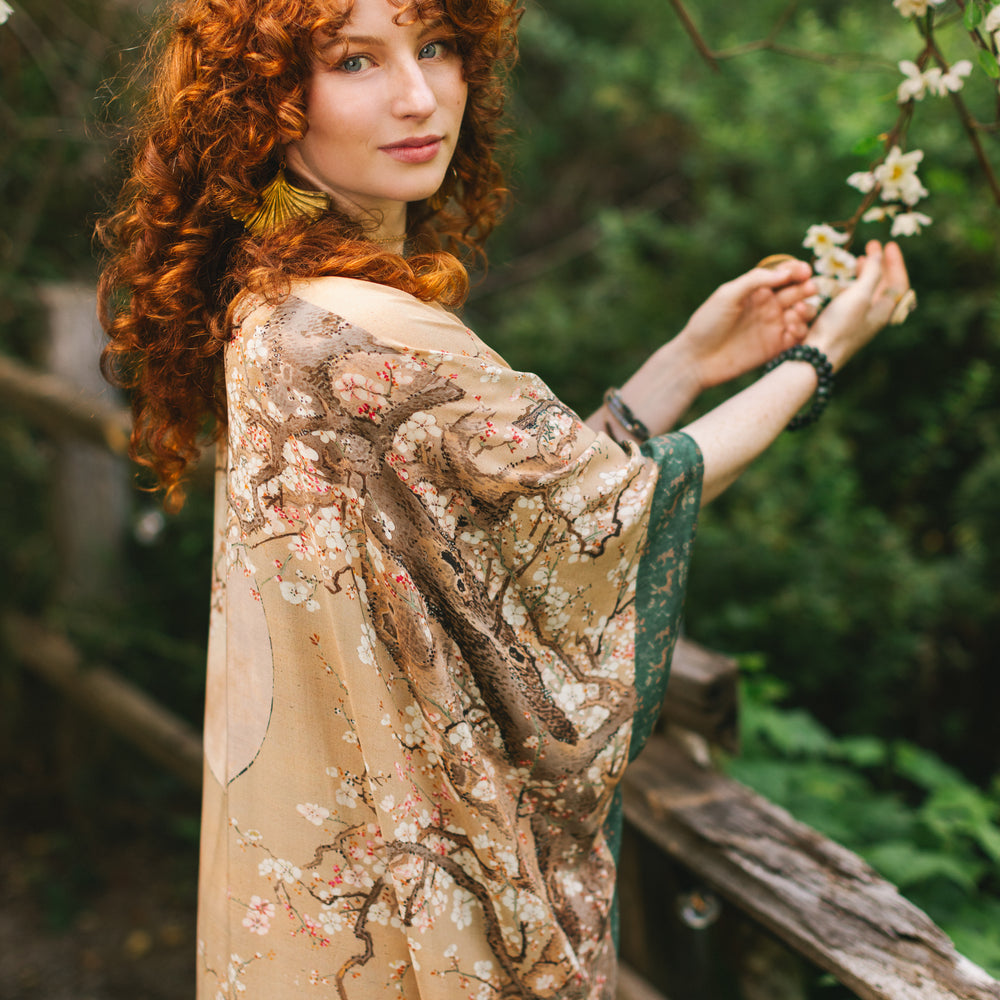 
                  
                    Model wearing Fable Goddess Duster featuring antique Japanese art, cherry and peach blossoms, nightingales, deer, and French block prints - Market of Stars
                  
                