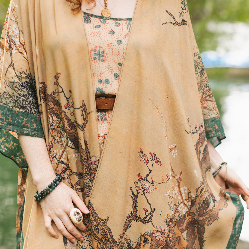
                  
                    Model wearing Fable Goddess Duster featuring antique Japanese art, cherry and peach blossoms, nightingales, deer, and French block prints - Market of Stars
                  
                