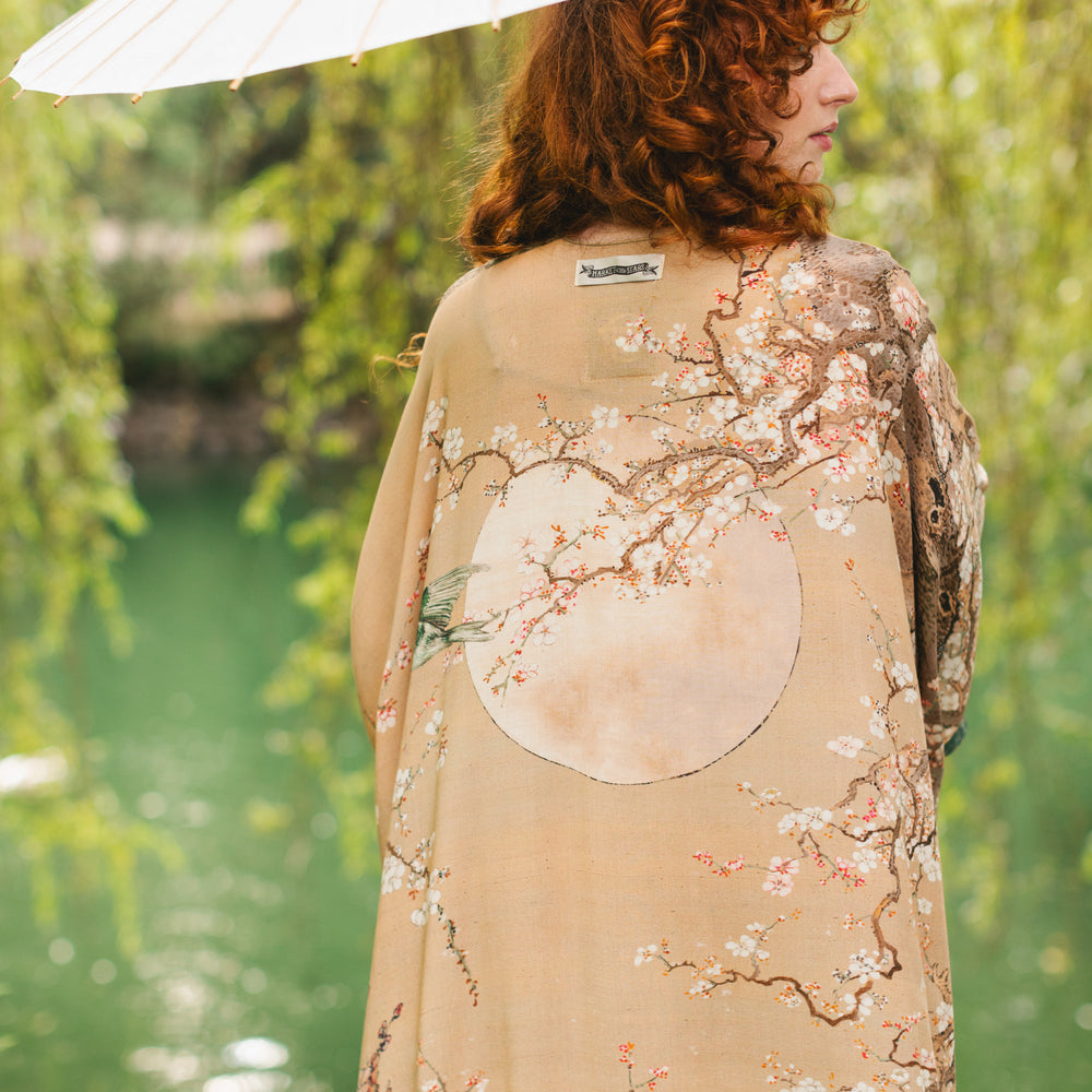 
                  
                    Model wearing Fable Goddess Duster featuring antique Japanese art, cherry and peach blossoms, nightingales, deer, and French block prints - Market of Stars
                  
                
