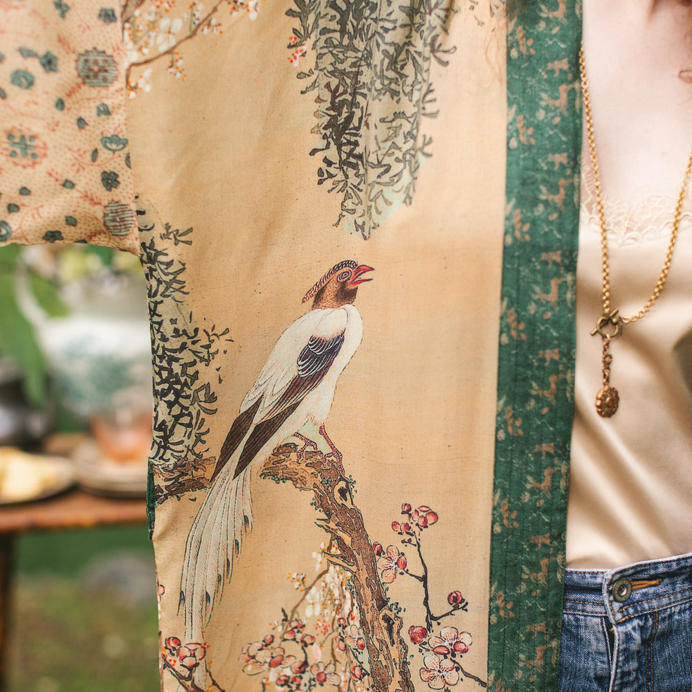 
                  
                    Model wearing Fable Opera Duster featuring antique Japanese art, cherry and peach blossoms, nightingales, deer, and French block prints - Market of Stars
                  
                