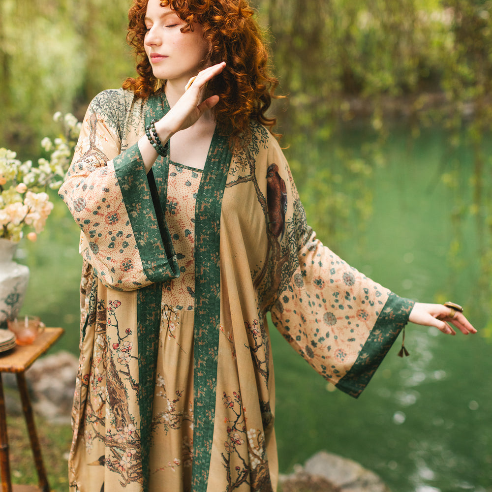 
                  
                    Model wearing Fable Opera Duster featuring antique Japanese art, cherry and peach blossoms, nightingales, deer, and French block prints - Market of Stars
                  
                
