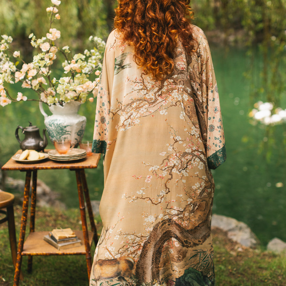 
                  
                    Model wearing Fable Opera Duster featuring antique Japanese art, cherry and peach blossoms, nightingales, deer, and French block prints - Market of Stars
                  
                