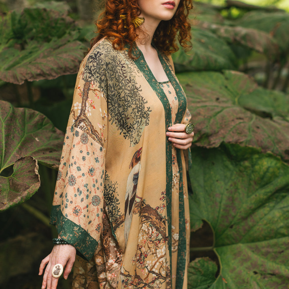 
                  
                    Model wearing Fable Opera Duster featuring antique Japanese art, cherry and peach blossoms, nightingales, deer, and French block prints - Market of Stars
                  
                