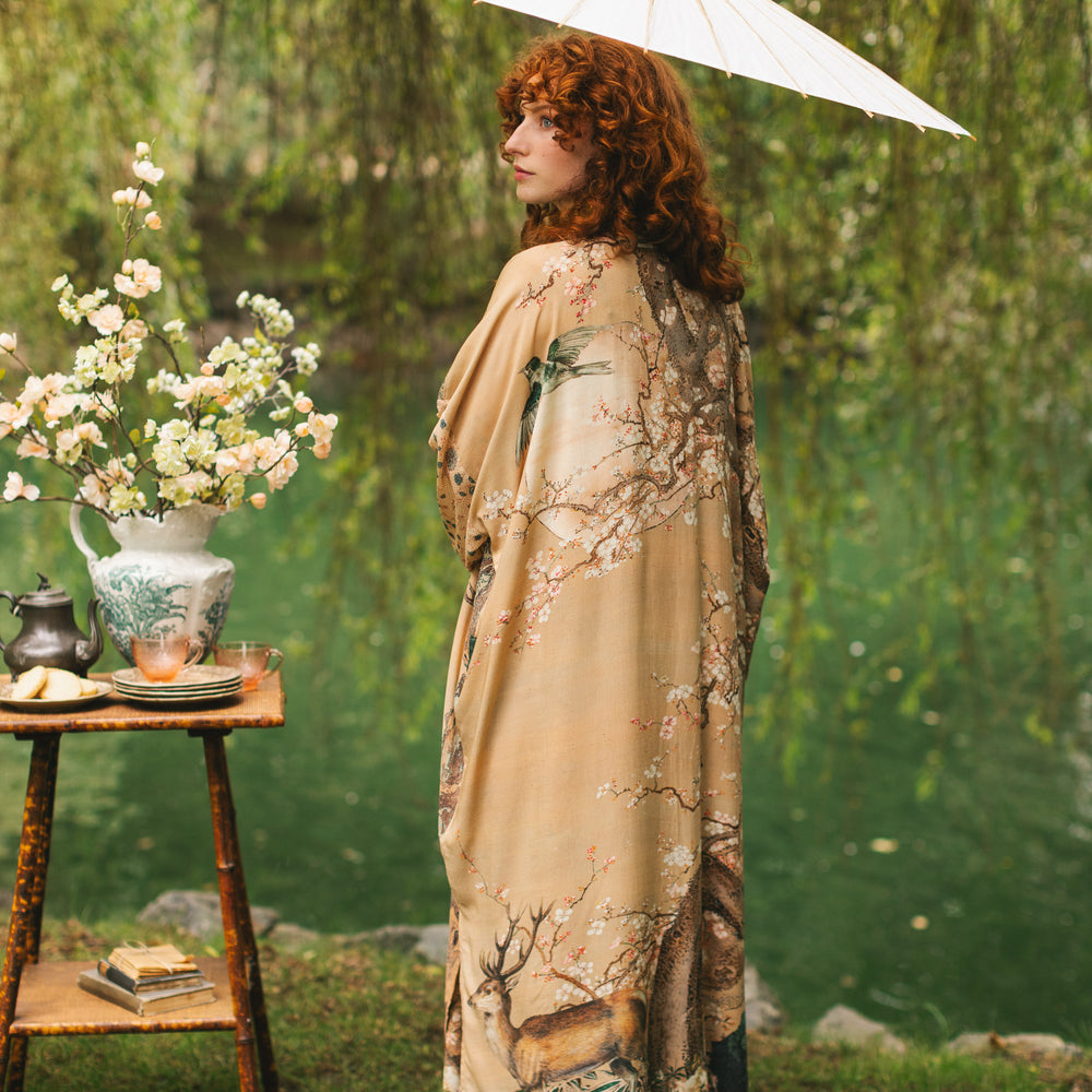 
                  
                    Model wearing Fable Opera Duster featuring antique Japanese art, cherry and peach blossoms, nightingales, deer, and French block prints - Market of Stars
                  
                