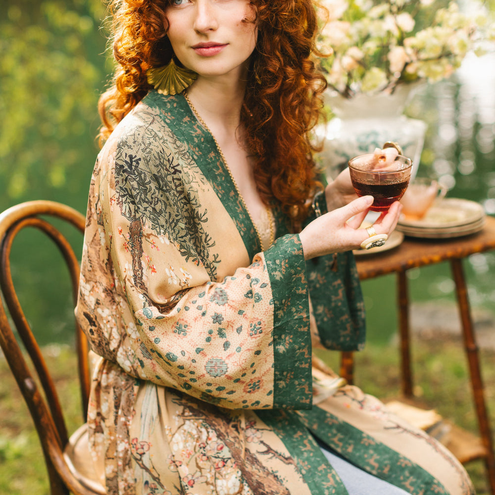 
                  
                    Model wearing Fable Opera Duster featuring antique Japanese art, cherry and peach blossoms, nightingales, deer, and French block prints - Market of Stars
                  
                