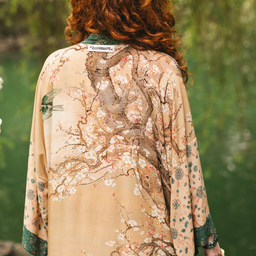 
                  
                    Model wearing Fable Opera Duster featuring antique Japanese art, cherry and peach blossoms, nightingales, deer, and French block prints - Market of Stars
                  
                