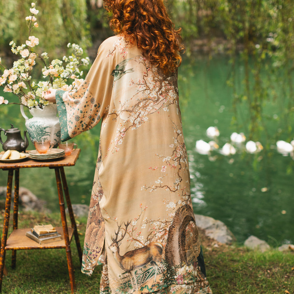 
                  
                    Model wearing Fable Opera Duster featuring antique Japanese art, cherry and peach blossoms, nightingales, deer, and French block prints - Market of Stars
                  
                
