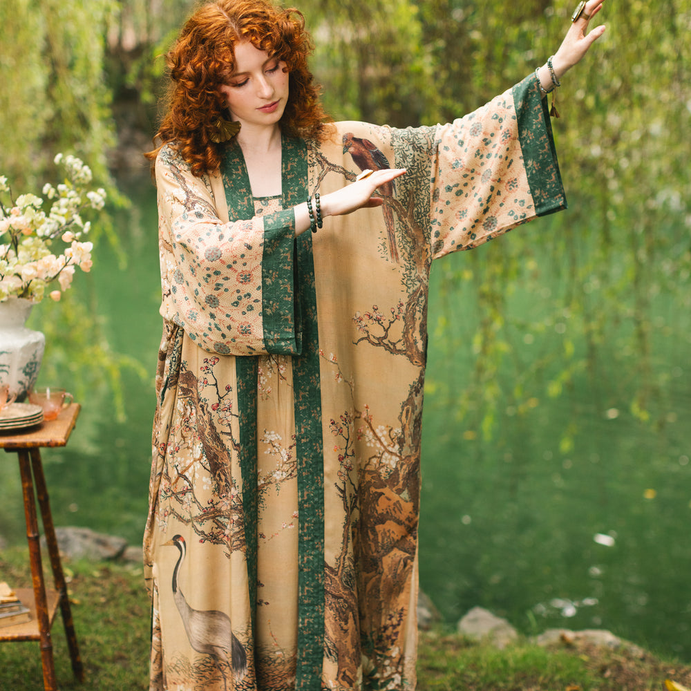 
                  
                    Model wearing Fable Opera Duster featuring antique Japanese art, cherry and peach blossoms, nightingales, deer, and French block prints - Market of Stars
                  
                