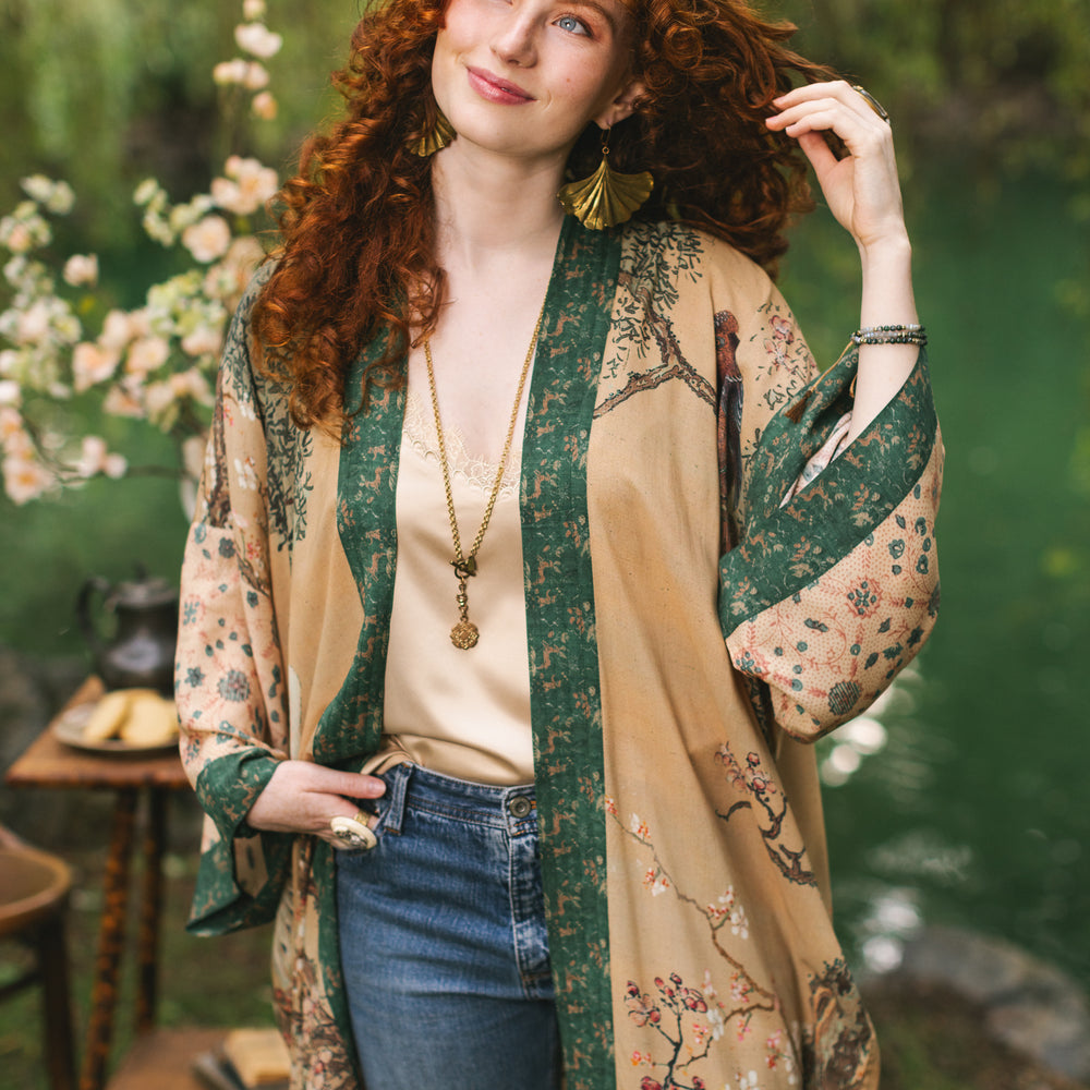 
                  
                    Model wearing Fable Opera Duster featuring antique Japanese art, cherry and peach blossoms, nightingales, deer, and French block prints - Market of Stars
                  
                