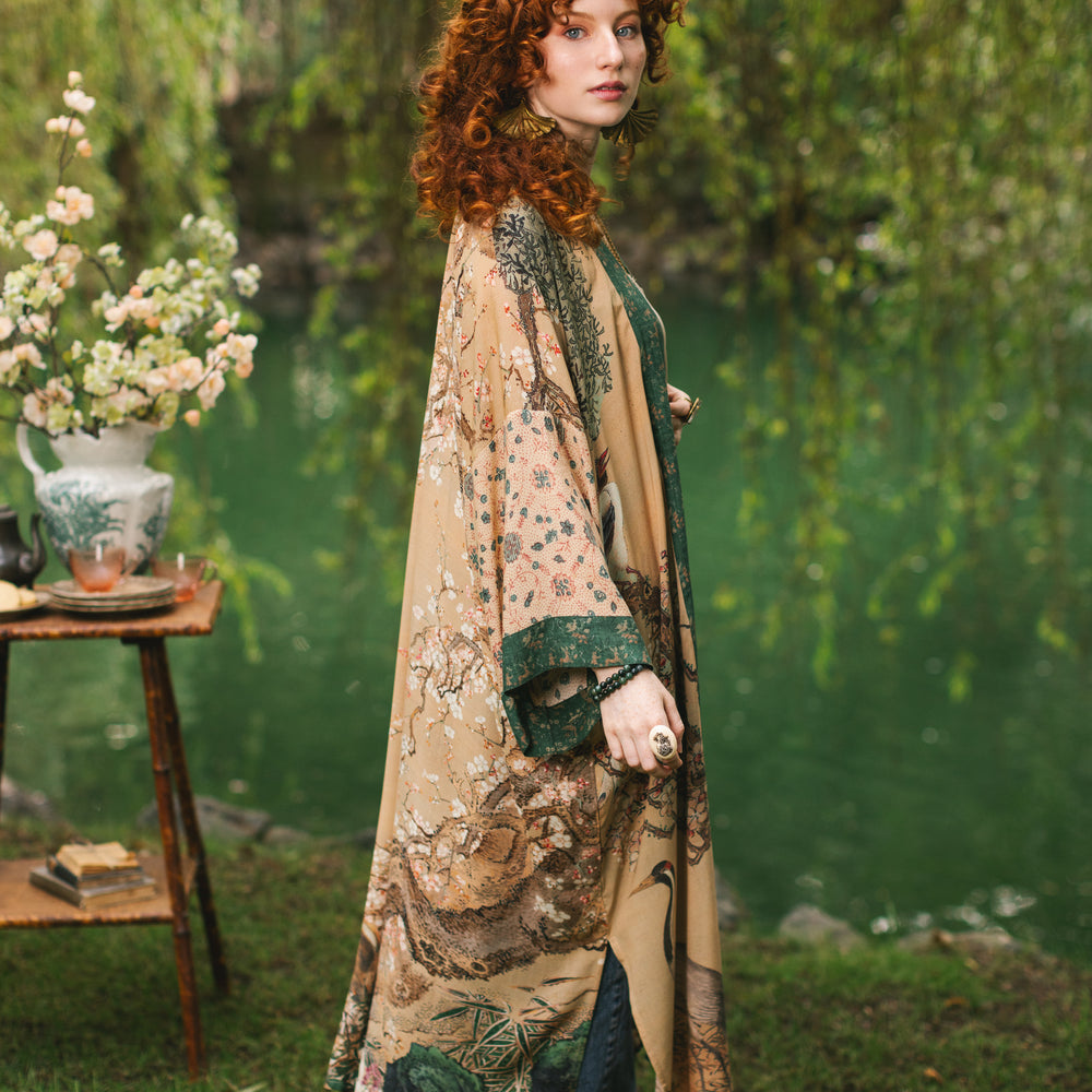 
                  
                    Model wearing Fable Opera Duster featuring antique Japanese art, cherry and peach blossoms, nightingales, deer, and French block prints - Market of Stars
                  
                