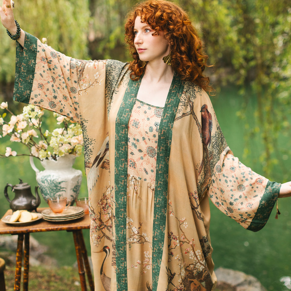 
                  
                    Model wearing Fable Opera Duster featuring antique Japanese art, cherry and peach blossoms, nightingales, deer, and French block prints - Market of Stars
                  
                