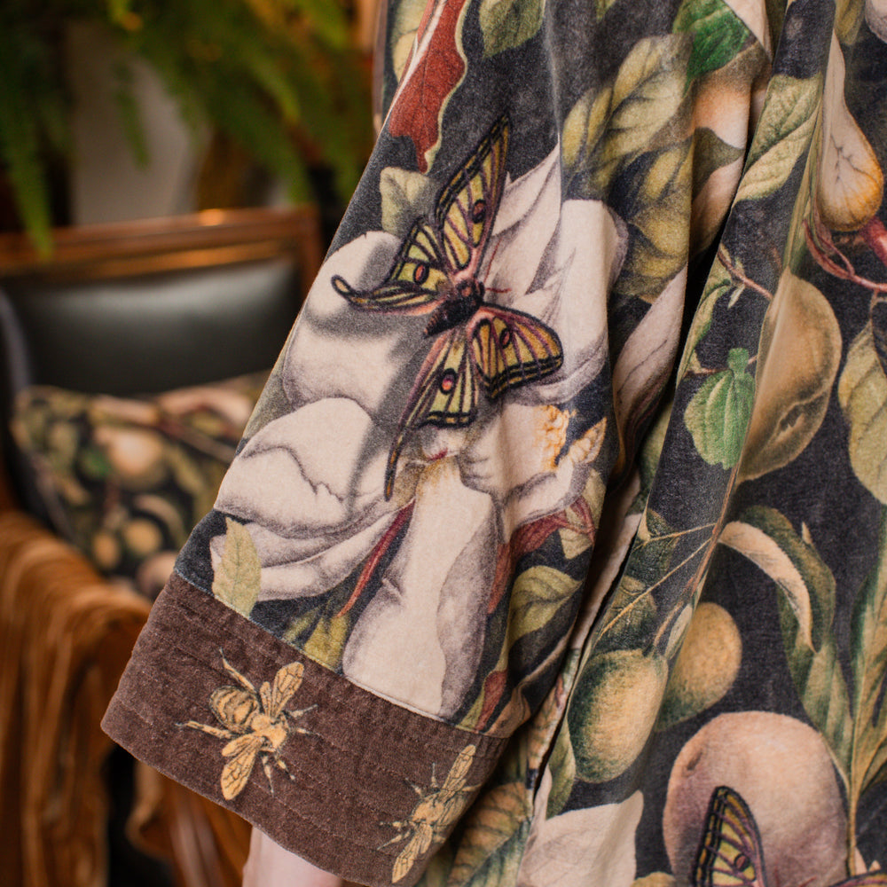 
                  
                    Model wearing a soft cotton velvet duster ft. vintage lithographs of magnolias & 1800's etchings of moths and pears - Market of Stars
                  
                