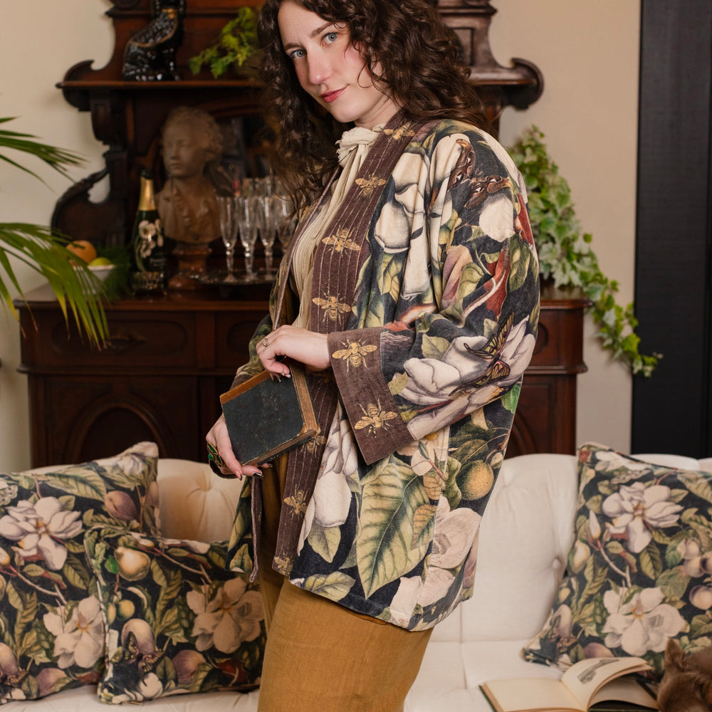 
                  
                    Model wearing a soft cotton velvet duster ft. vintage lithographs of magnolias & 1800's etchings of moths and pears - Market of Stars
                  
                