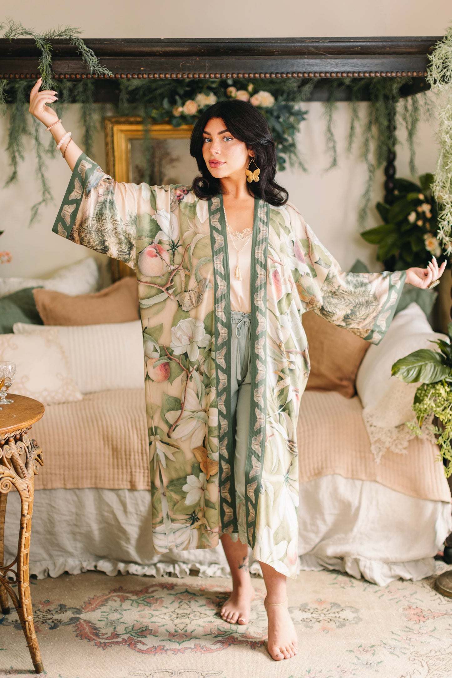 Model wearing a full-length duster robe inspired by antique florals, butterflies, and sunlit gardens, this flowing duster captures the warmth and magic of golden hour - Market of Stars