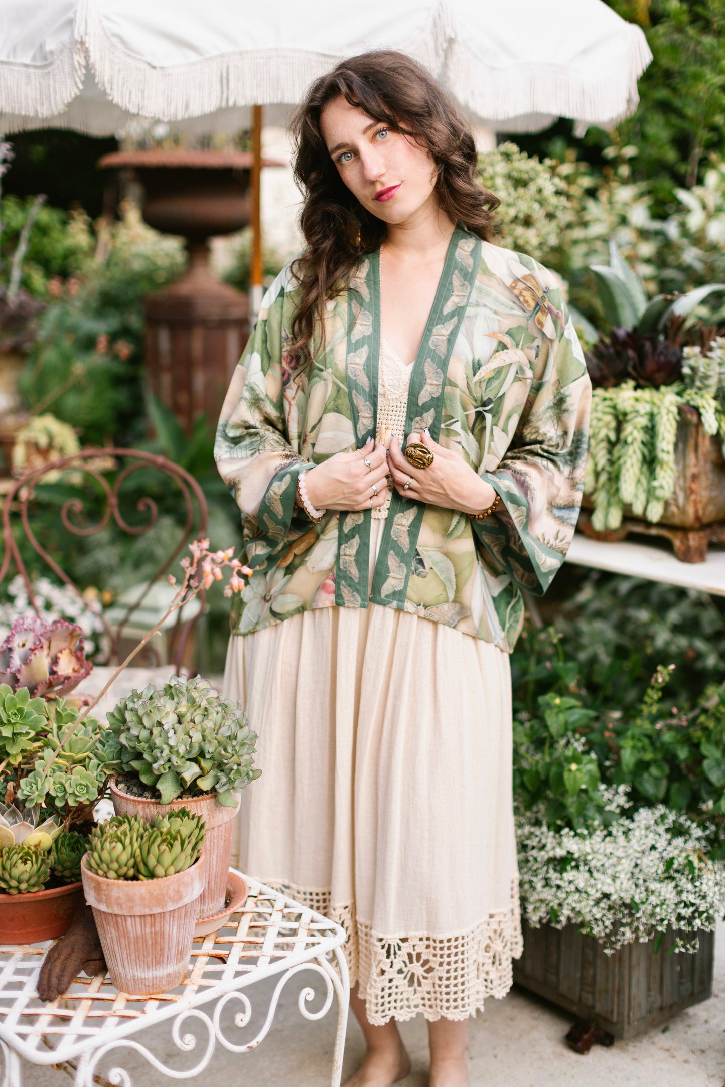 Model wearing a cropped length duster inspired by antique florals, butterflies, and sunlit gardens, this flowing duster captures the warmth and magic of golden hour - Market of Stars