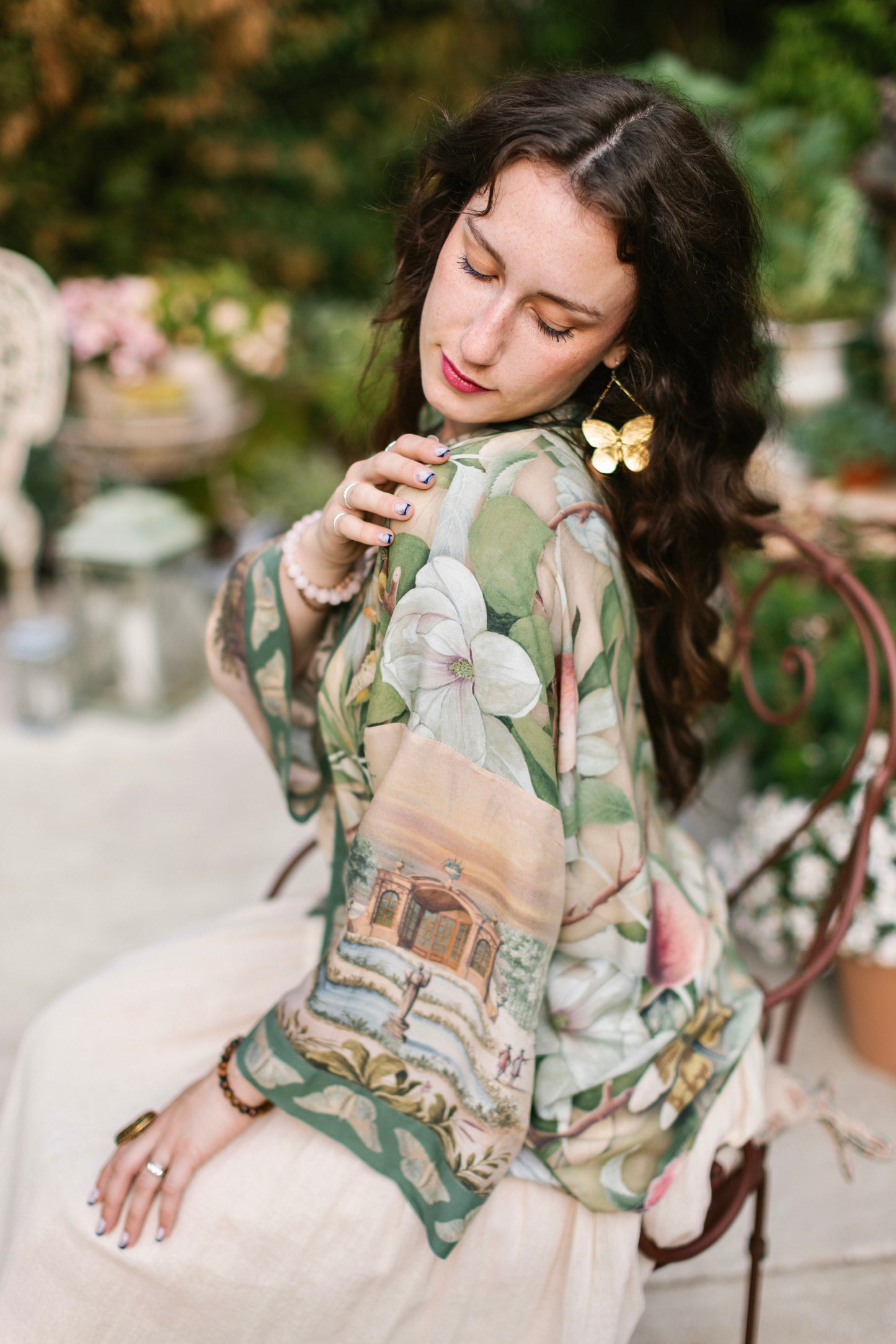 Model wearing a cropped length duster inspired by antique florals, butterflies, and sunlit gardens, this flowing duster captures the warmth and magic of golden hour - Market of Stars