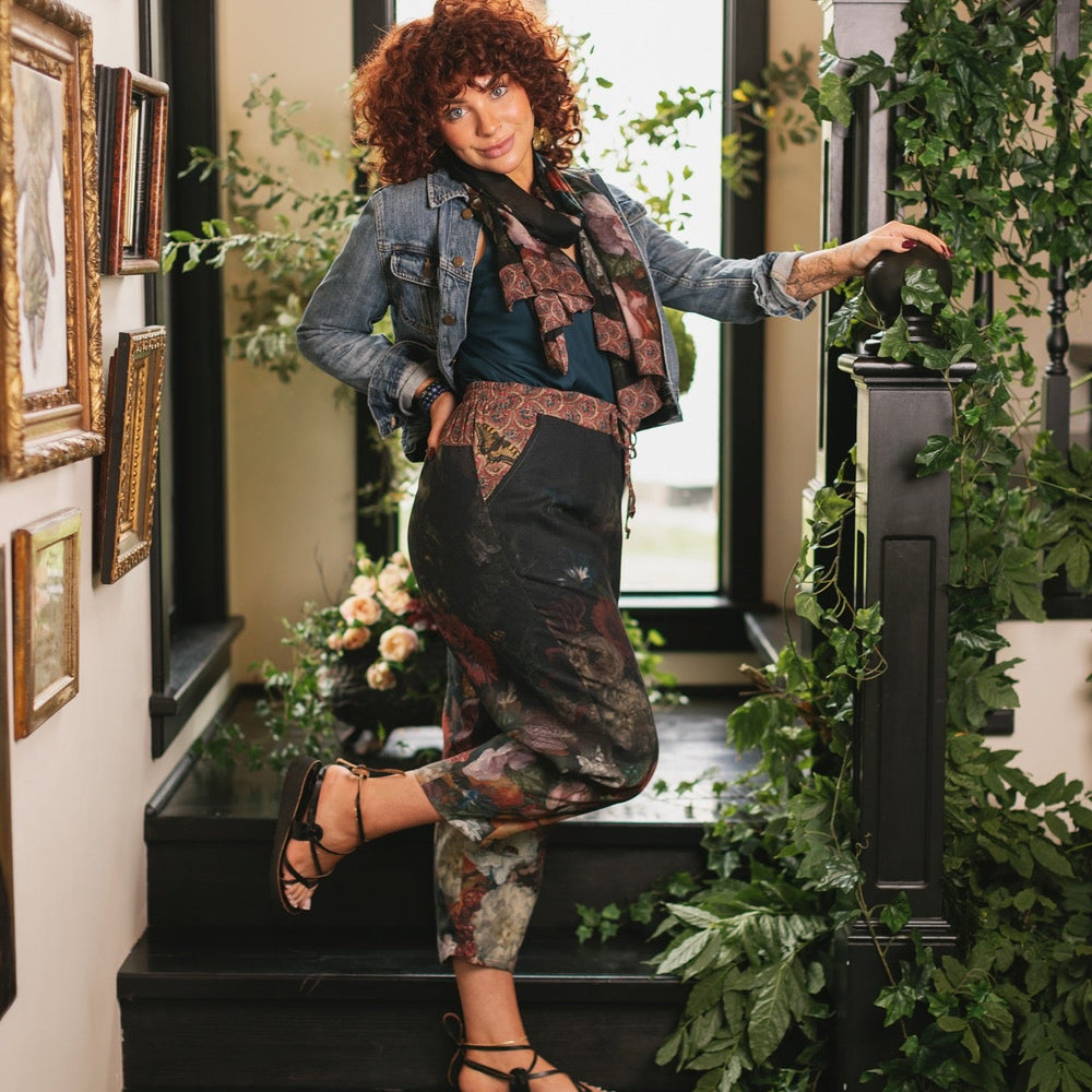 
                  
                    Model wearing the Folklore Artist Pant featuring the Bird-of-Peace embroidery and unfinished William Morris textile designs—artful linen blend pants by Market of Stars.
                  
                
