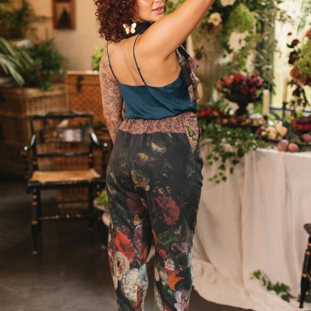 
                  
                    Model wearing the Folklore Artist Pant featuring the Bird-of-Peace embroidery and unfinished William Morris textile designs—artful linen blend pants by Market of Stars.
                  
                