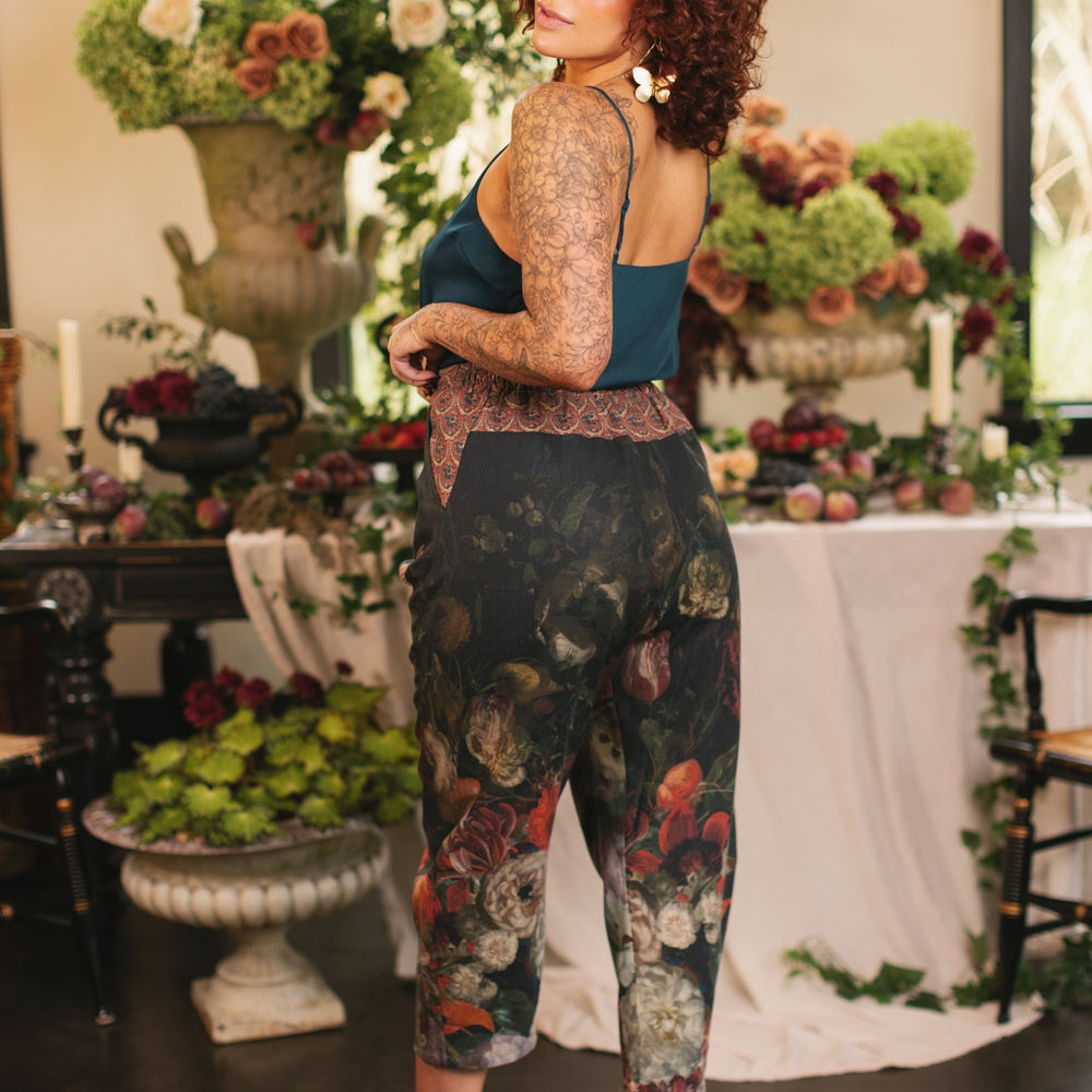 
                  
                    Model wearing the Folklore Artist Pant featuring the Bird-of-Peace embroidery and unfinished William Morris textile designs—artful linen blend pants by Market of Stars.
                  
                