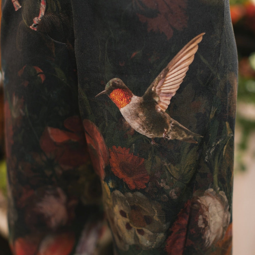 
                  
                    Model wearing the Folklore Artist Pant featuring the Bird-of-Peace embroidery and unfinished William Morris textile designs—artful linen blend pants by Market of Stars.
                  
                
