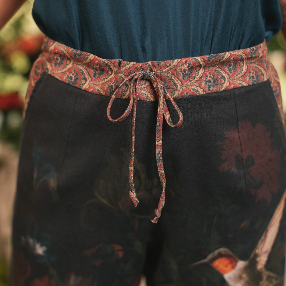 
                  
                    Model wearing the Folklore Artist Pant featuring the Bird-of-Peace embroidery and unfinished William Morris textile designs—artful linen blend pants by Market of Stars.
                  
                