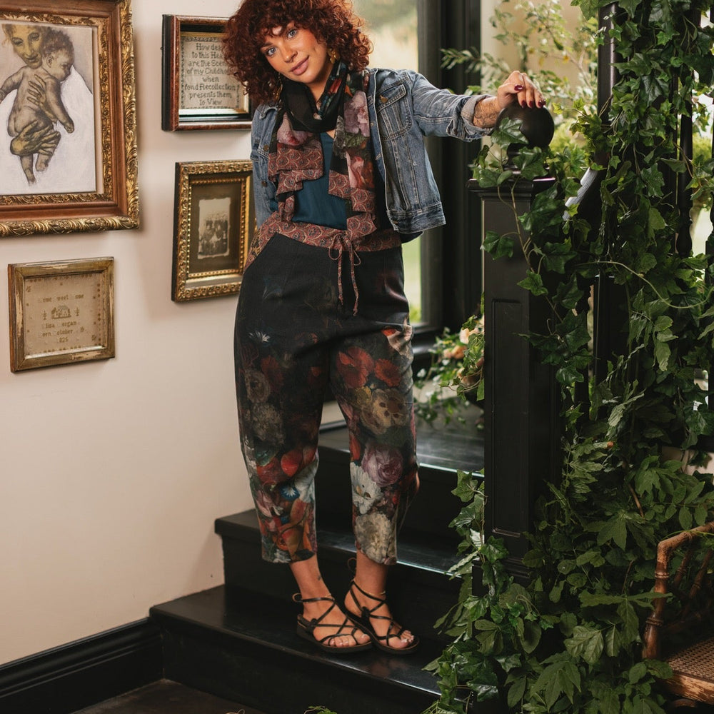 
                  
                    Model wearing the Folklore Artist Pant featuring the Bird-of-Peace embroidery and unfinished William Morris textile designs—artful linen blend pants by Market of Stars.
                  
                